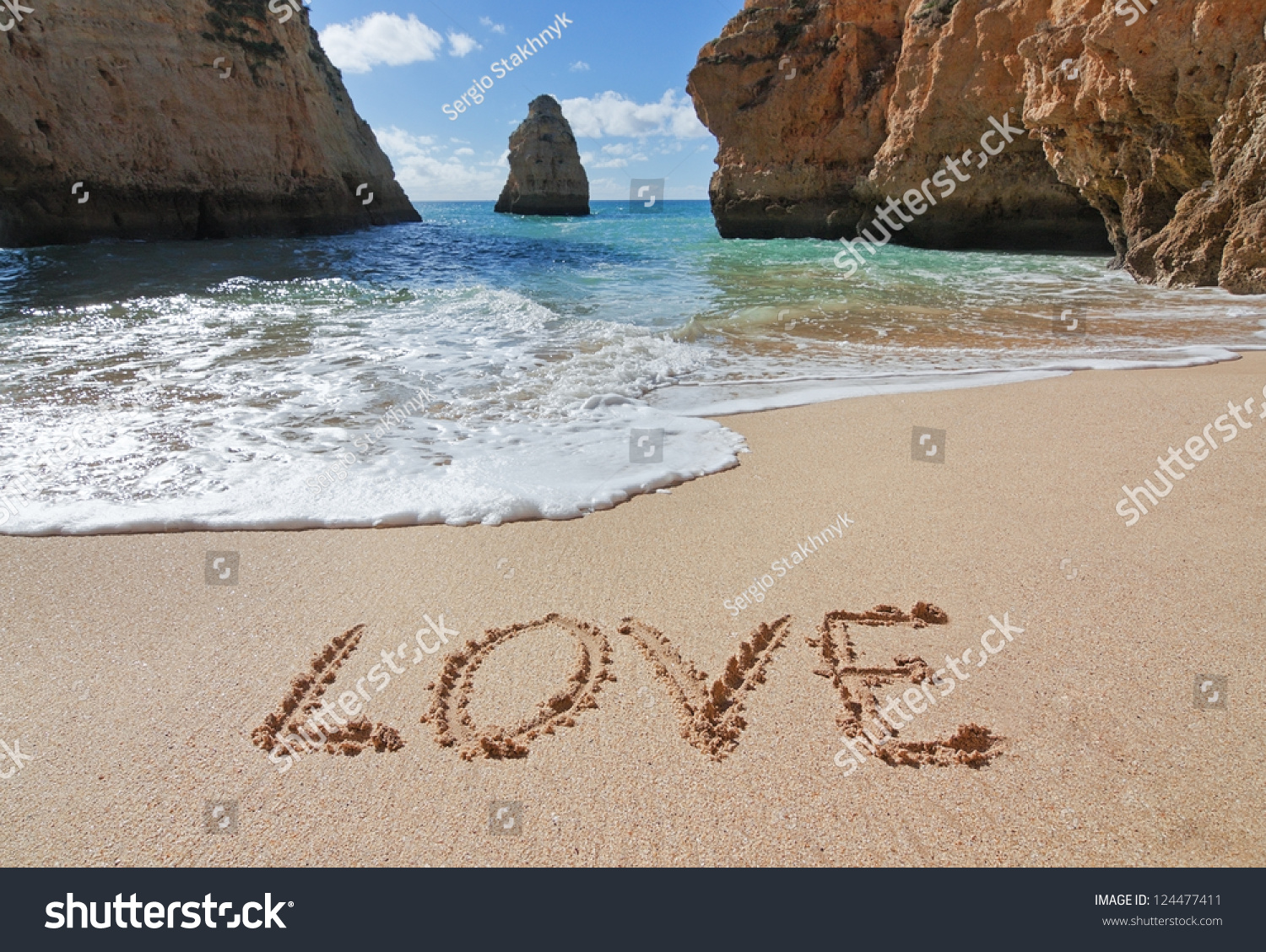 Word love in the sand at the beach on Valentine Day.