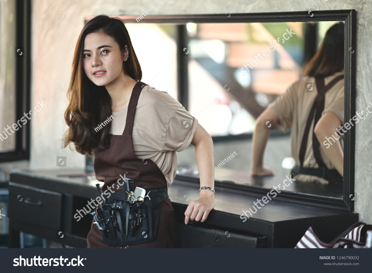Portrait of Asian barber girl in a beauty salon.
