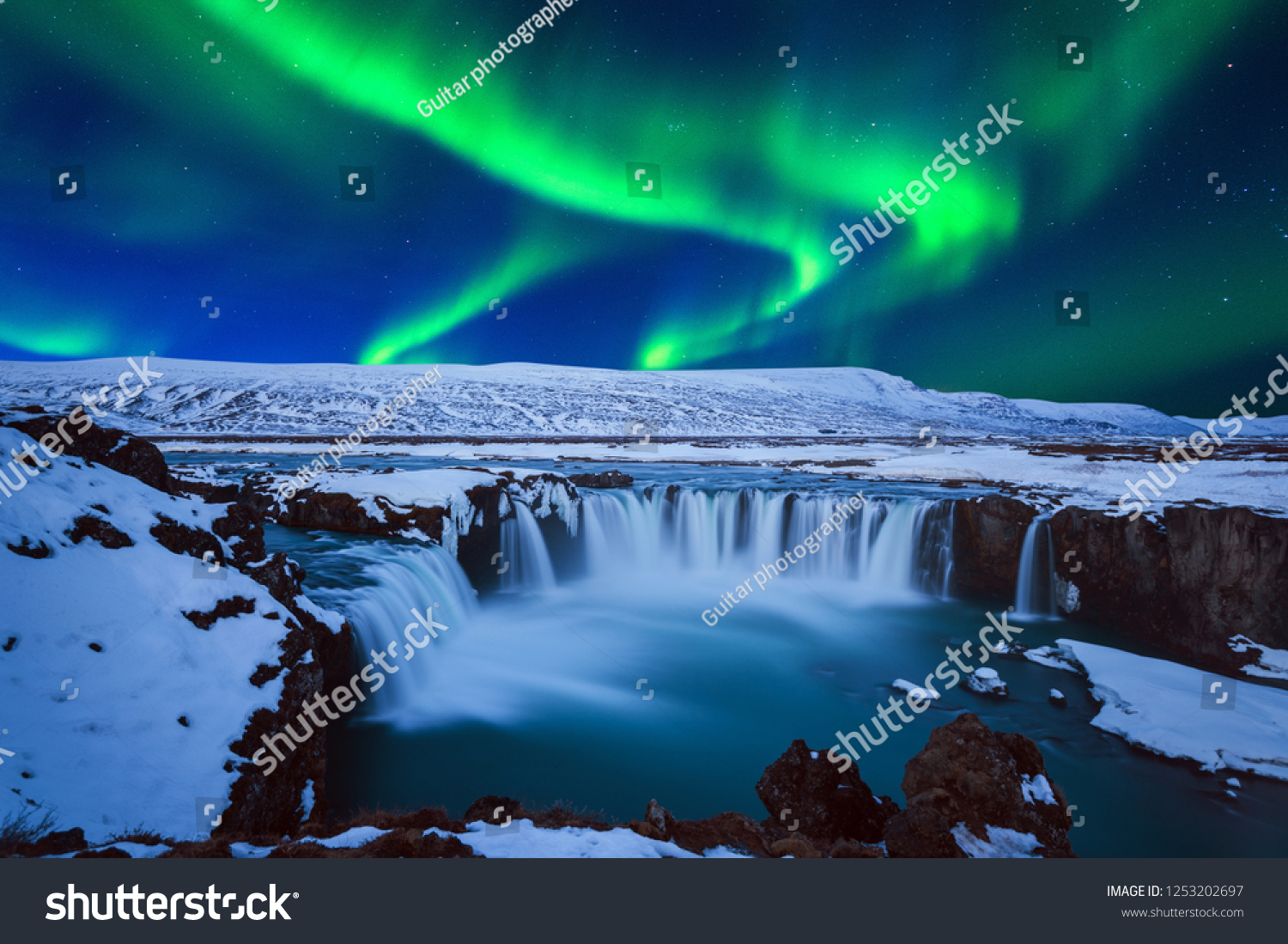 Northern Light  Aurora borealis at Godafoss waterfall in winter  Iceland.