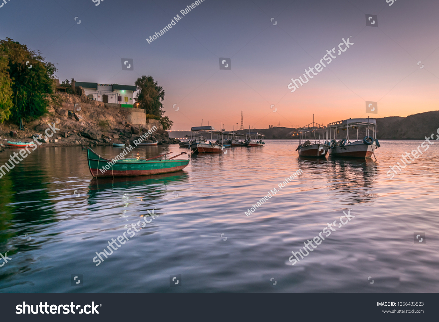 Sunset in Heisa island  nile and reflection of boats in Aswan Egypt