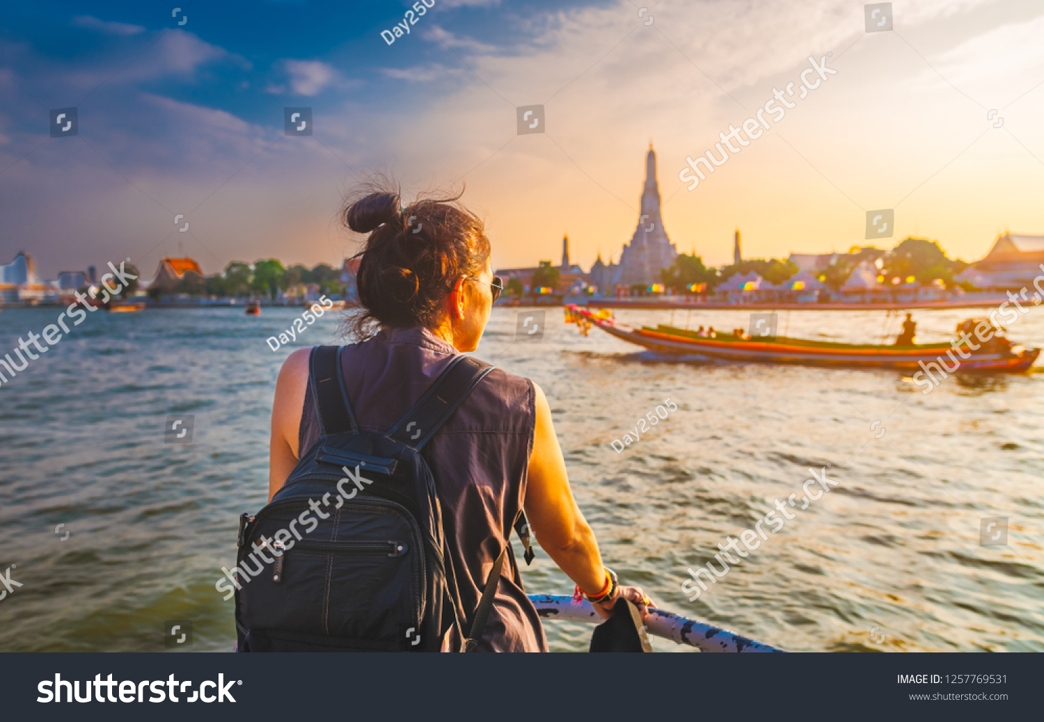 Traveler woman on boat joy view Wat Arun at sunset Chao Phraya river Famous water landmark travel Bangkok Thailand tourist female on holiday vacation trips Tourism beautiful destination place Asia