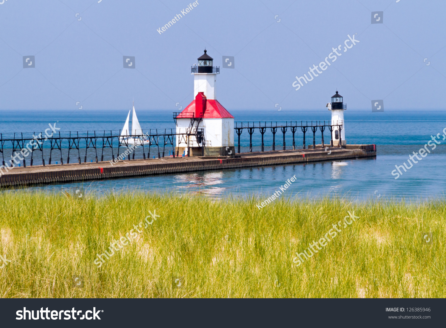 St. Joseph  Michigan North Pier Lighthouses with a Sailboat on Lake Michigan.
