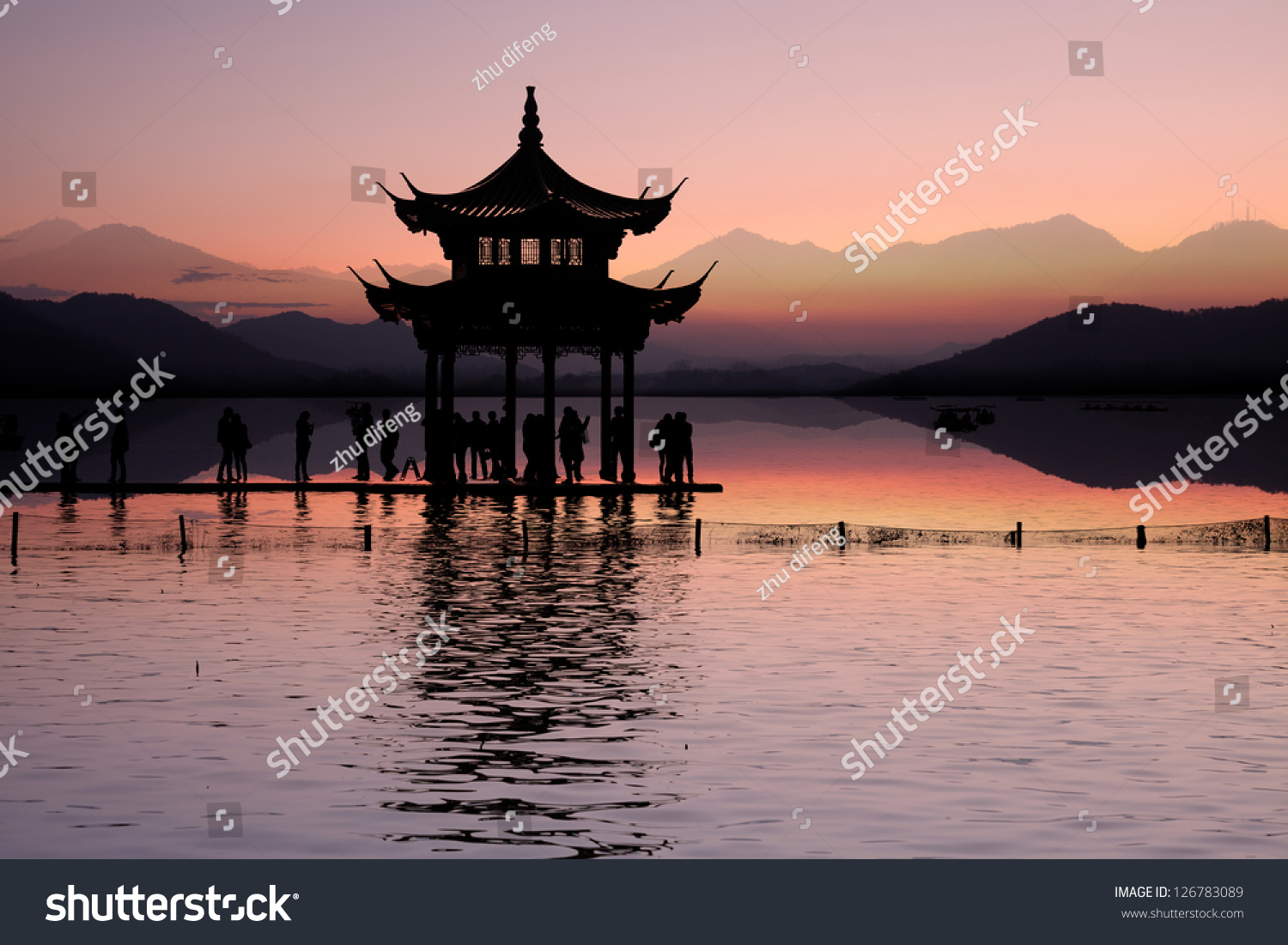 ancient pavilion on the west lake with sunset in hangzhou China.
