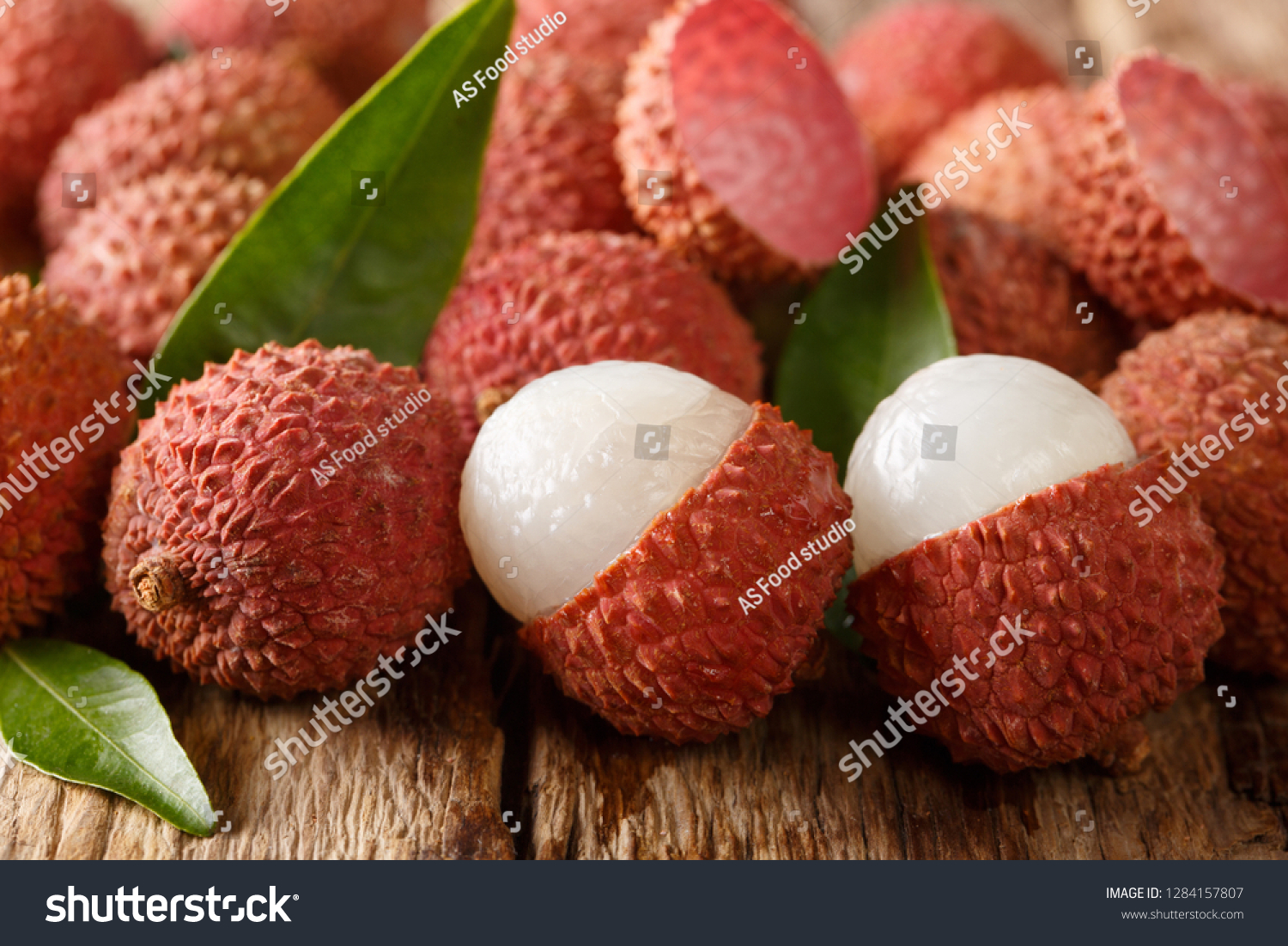 litchi lichee lychee or lichi Litchi chinensis on old rustic wood background with copy space. horizontal