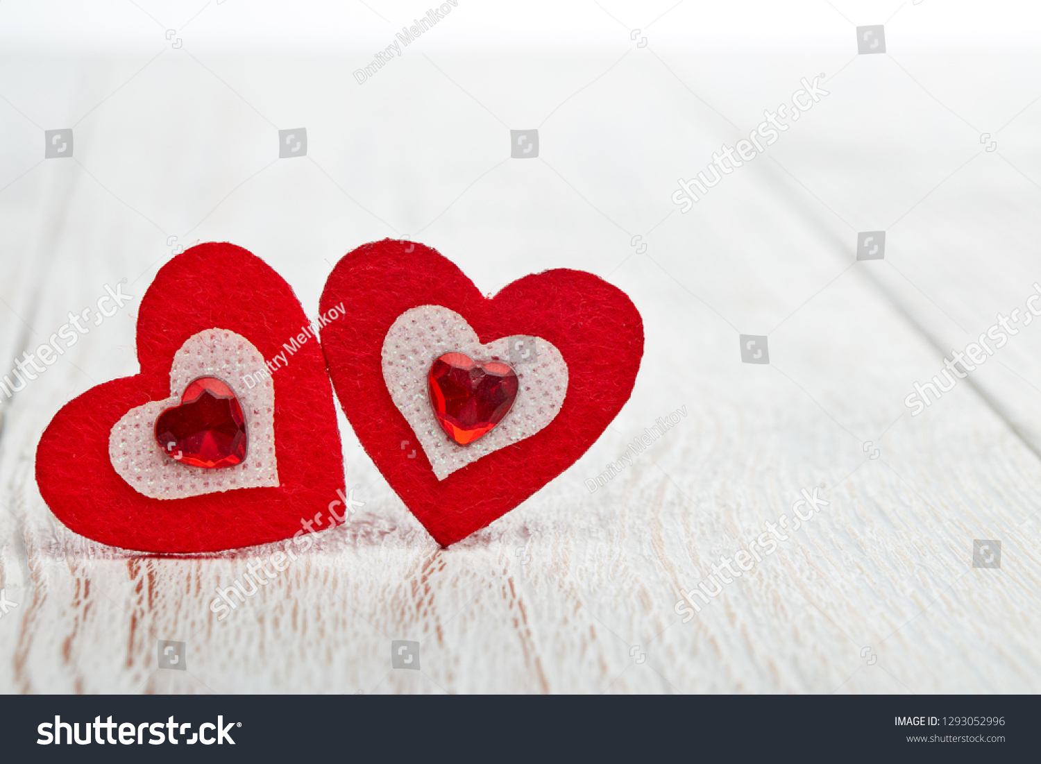 twodecorativeheartsonalightwoodenbackgroundwithcopyspace