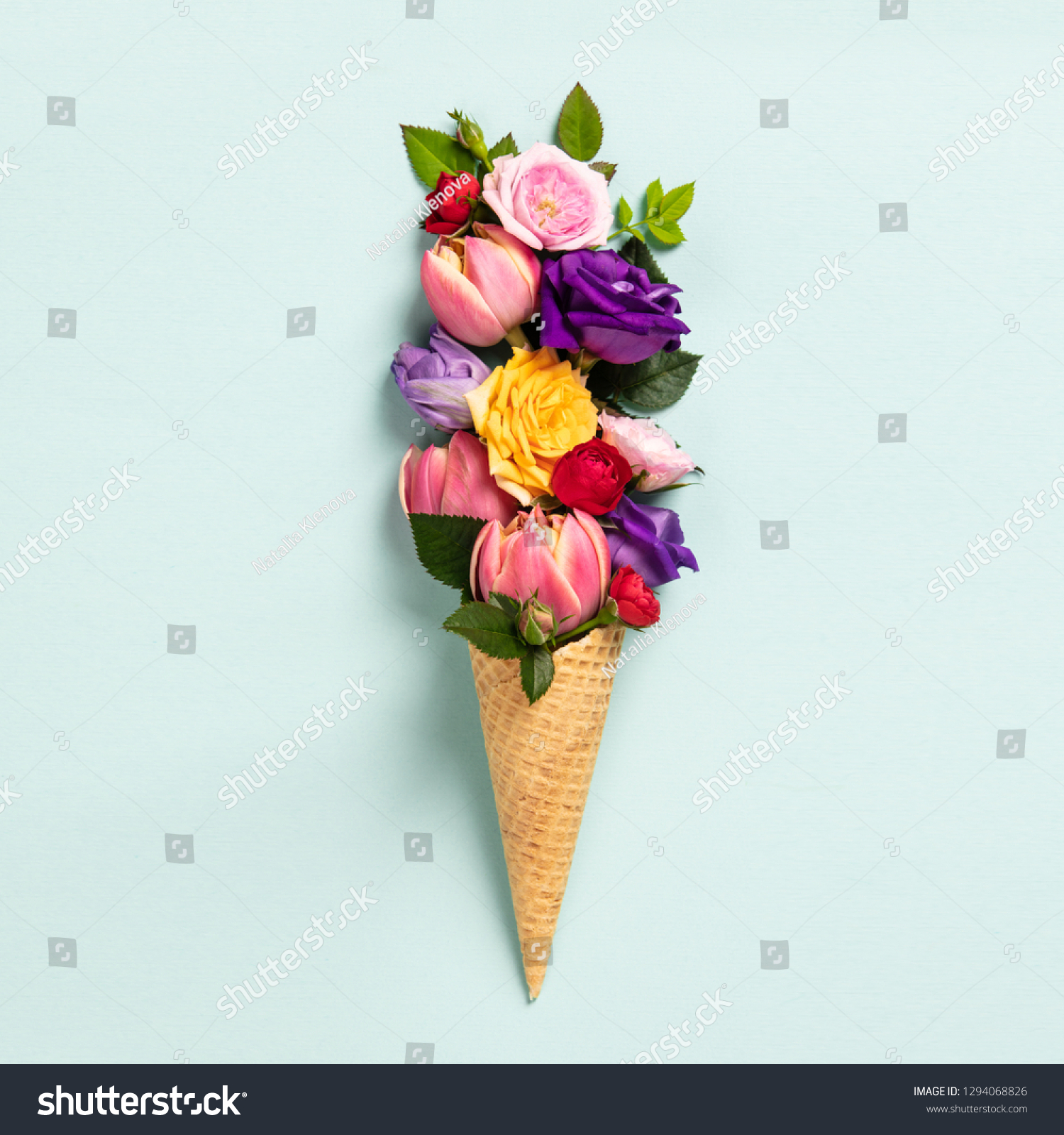 Ice cream cone with flowers and leaves. Summer minimal concept. 