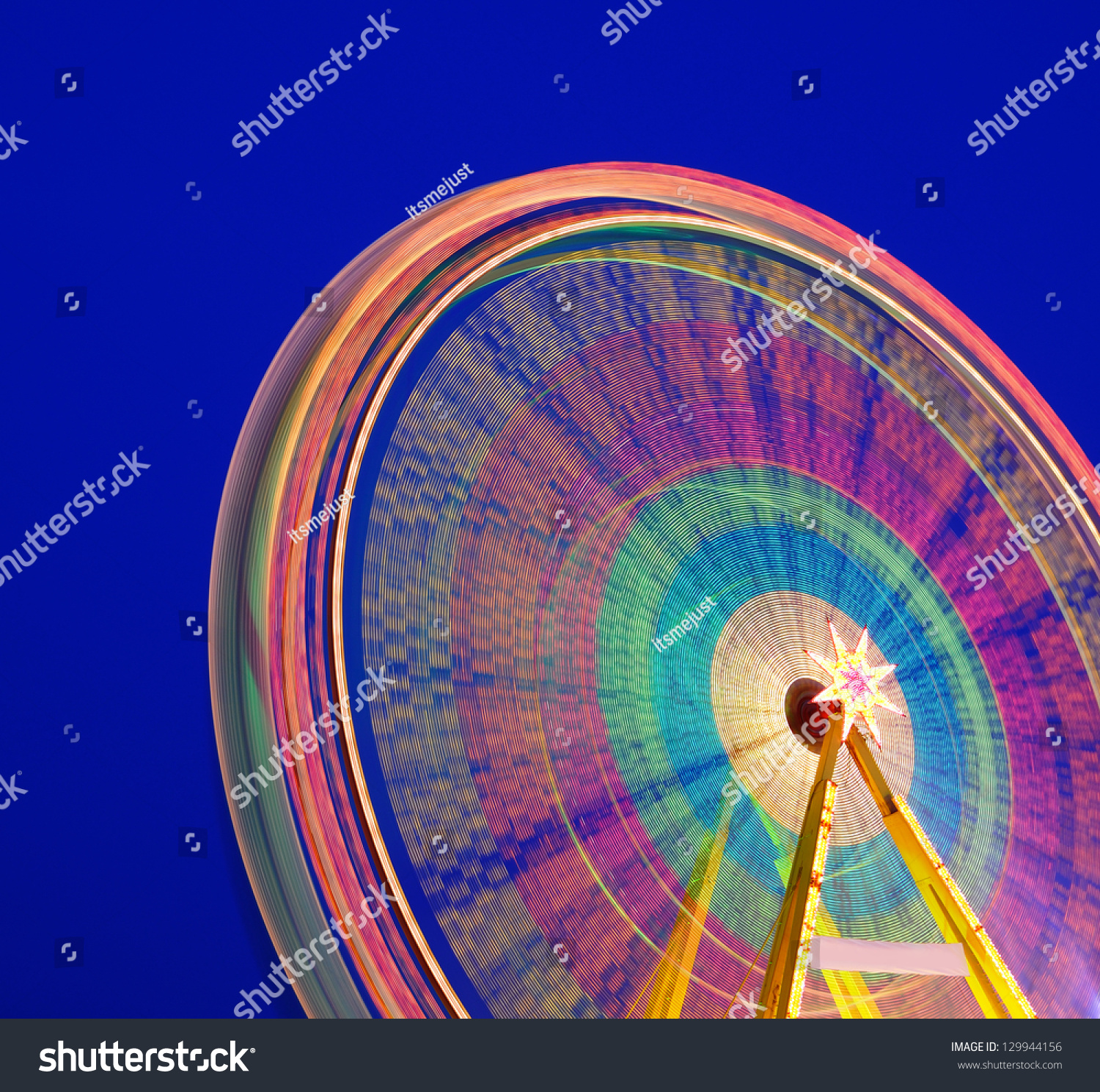 Carousel. Ferris Wheel on a blue background. Long time exposure.