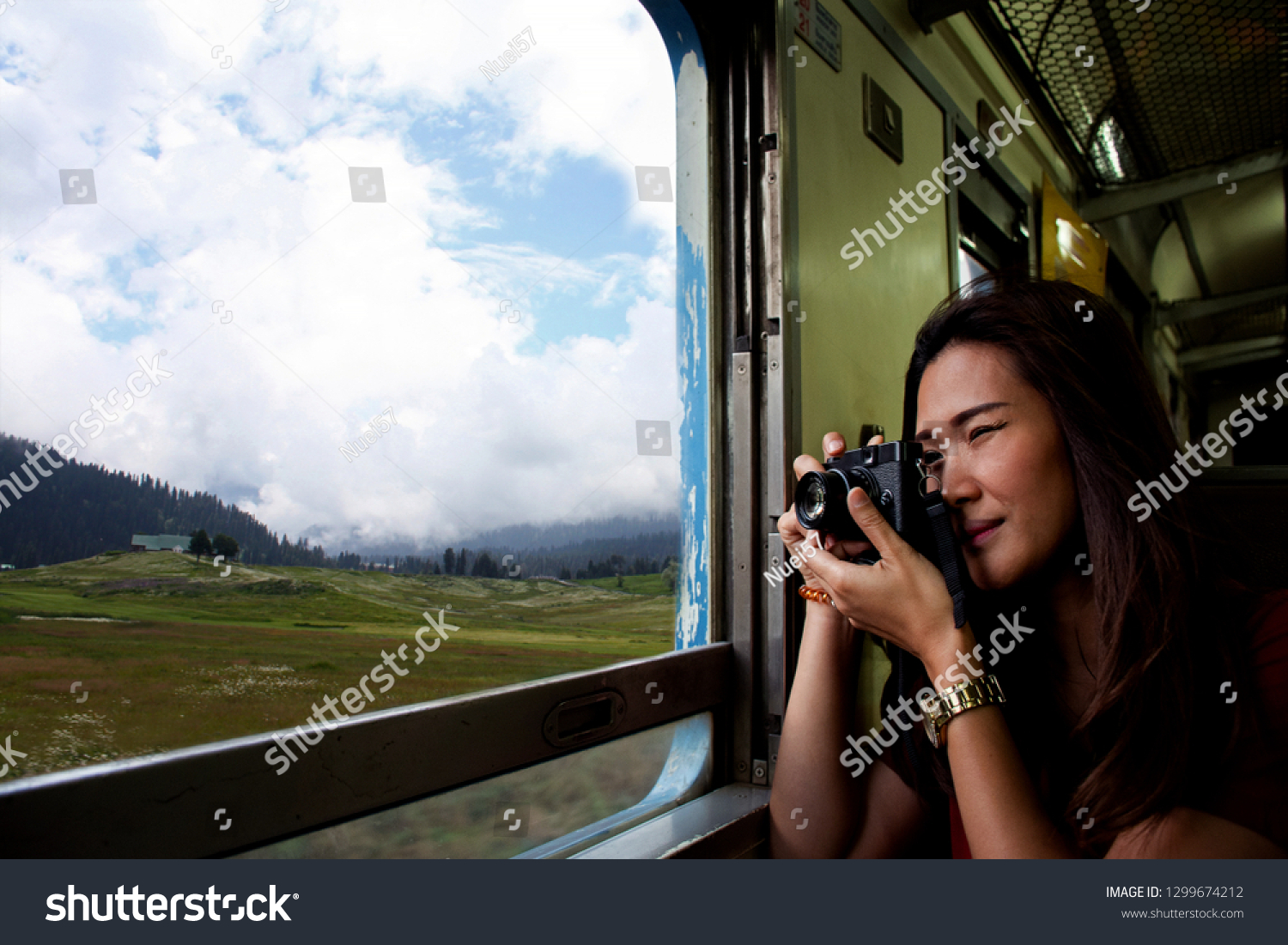 ฺBeautiful Asian woman makes a photo through from the train window