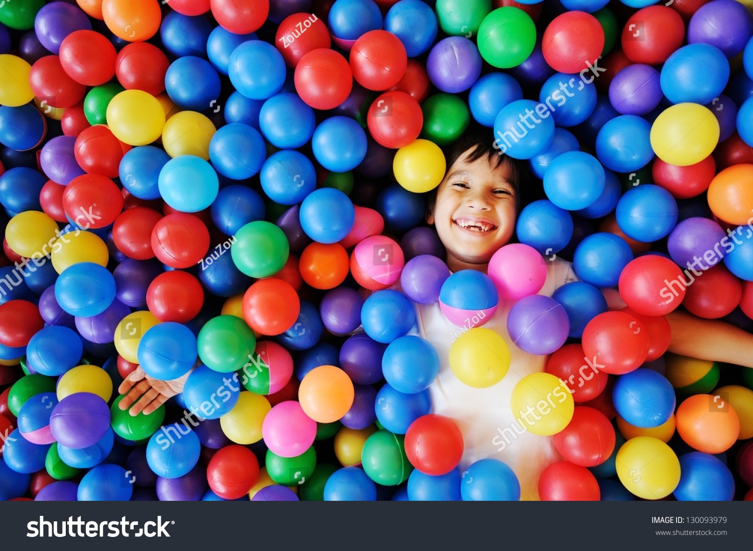 Happy children playing and having fun at kindergarten with colorful balls