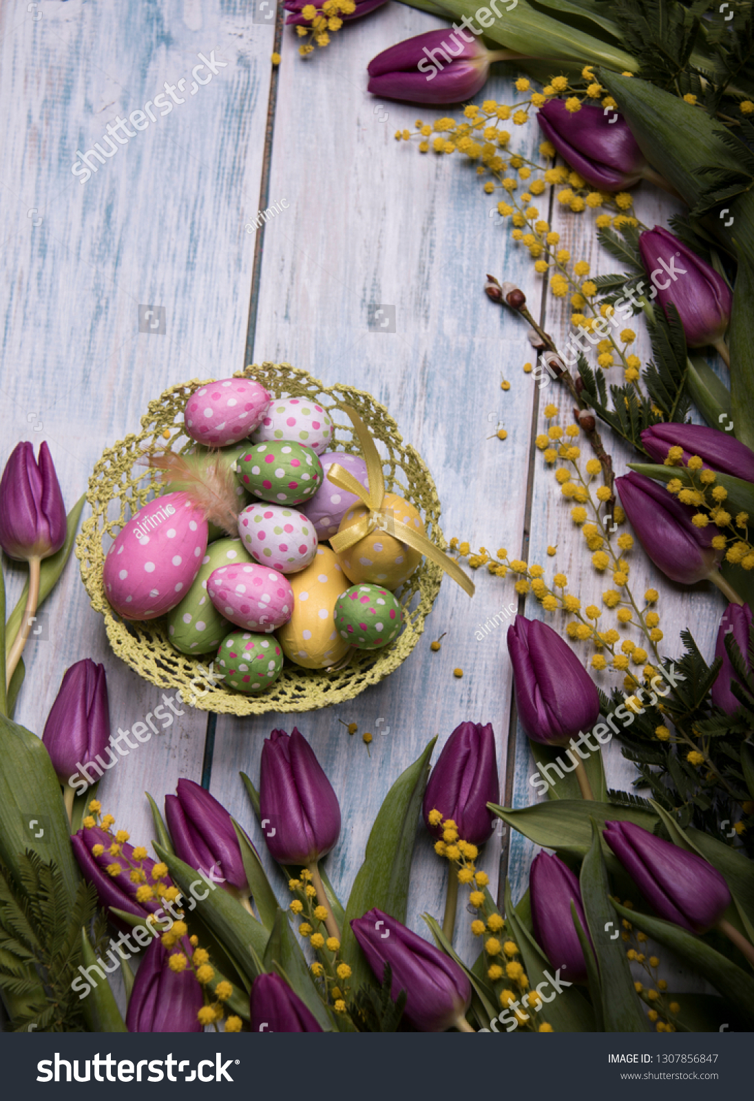 easter concept with easter eggs and spring flowers