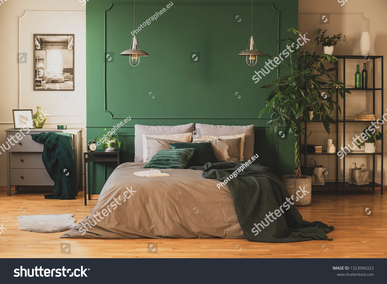 Industrial bookshelf and wooden commode in contemporary bedroom interior with urban jungle