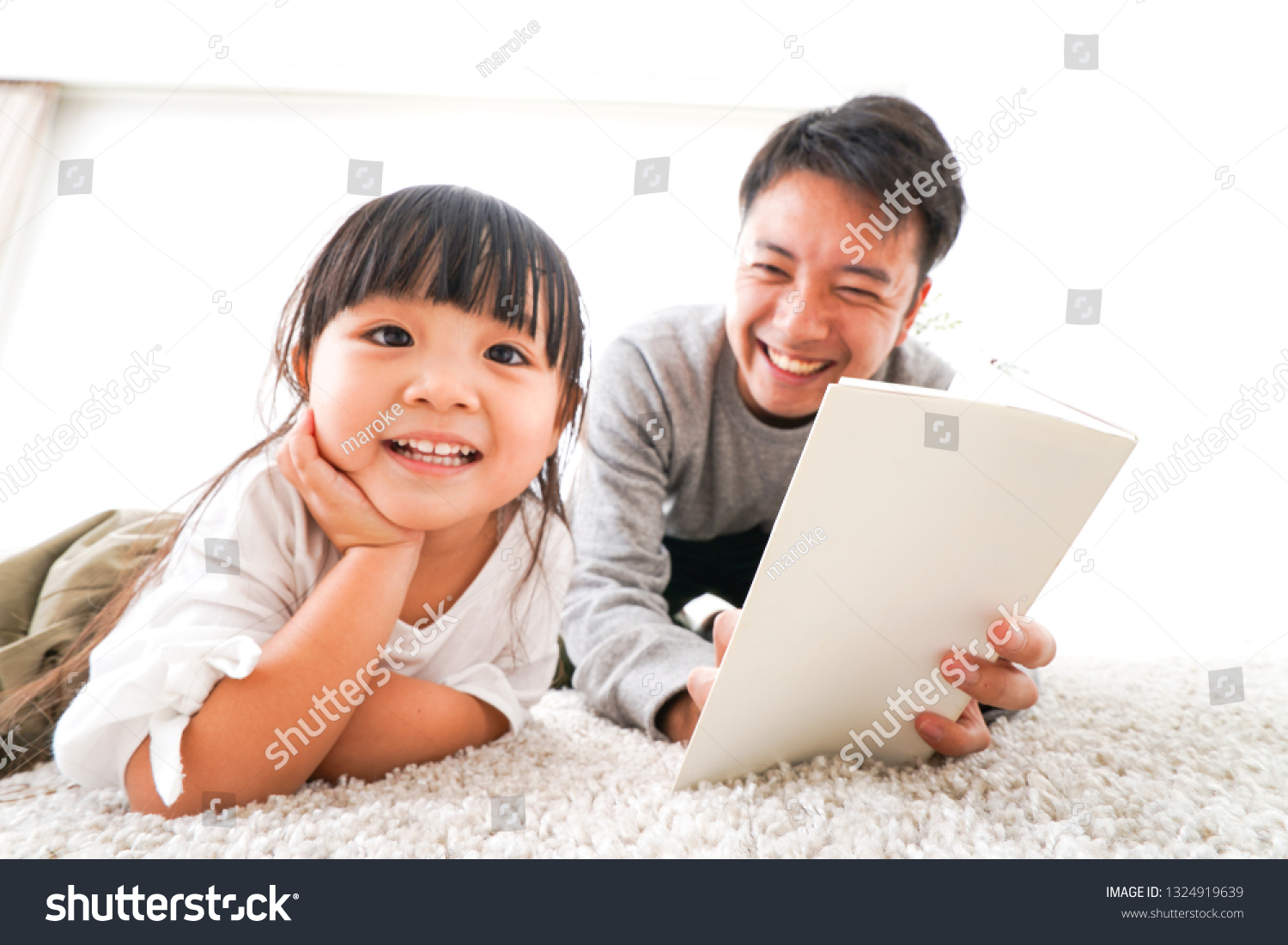 Father reading a book to his child