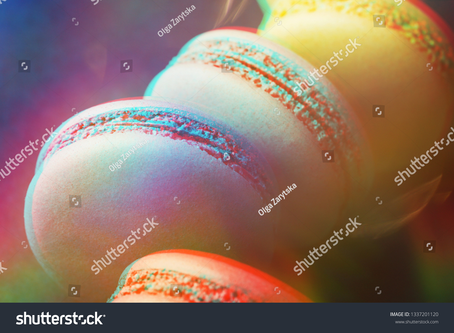 Colorful macarons on dark blue background with 3D effect. Top view  close up.