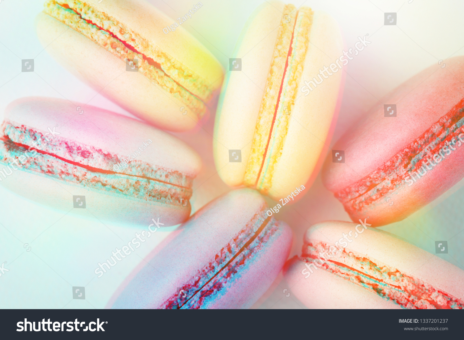 Row of colorful macarons on turquoise background. Top view  close up  3D effect  toned image.