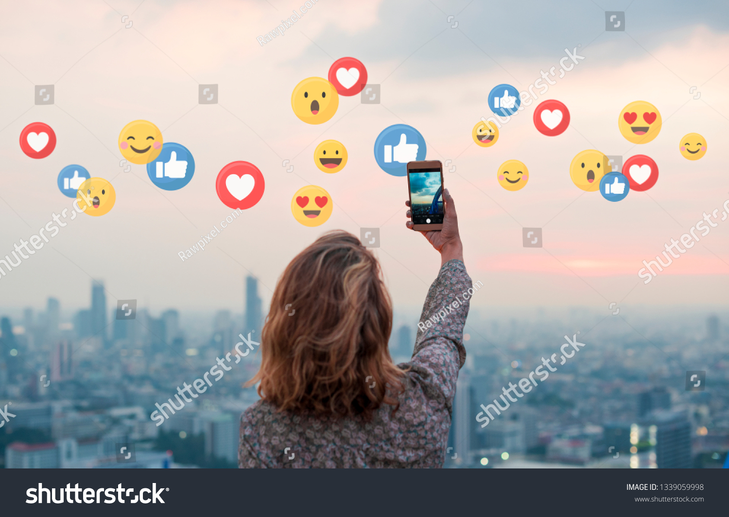 Woman taking a photo of the sunset