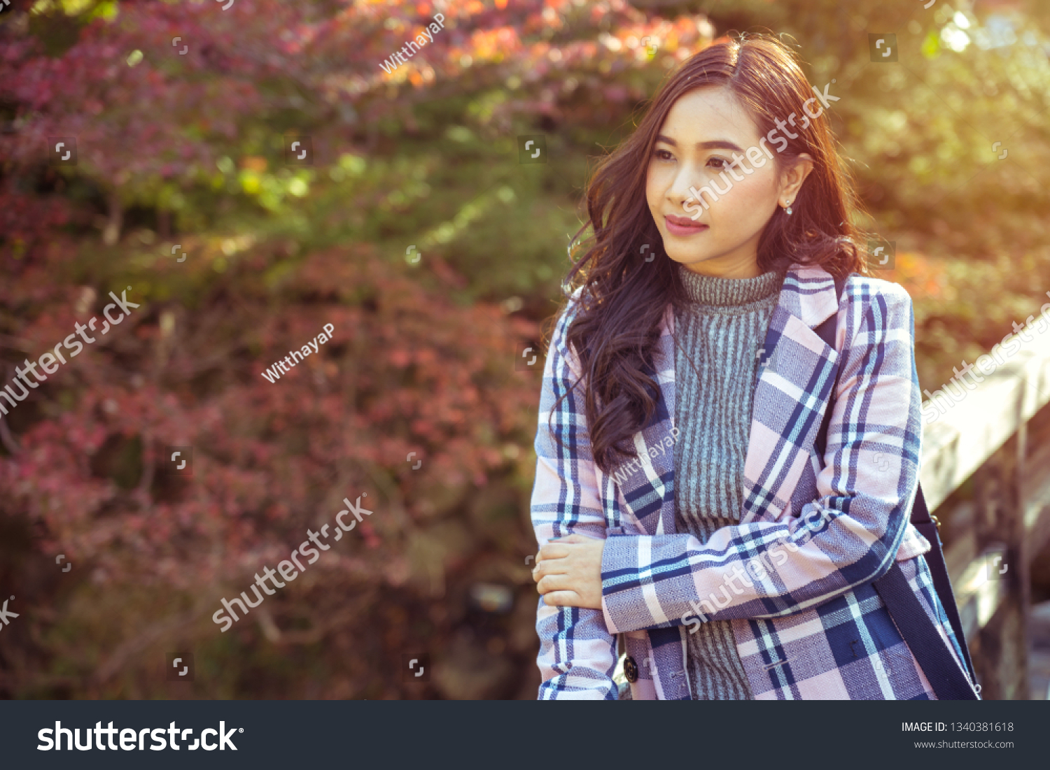 Portrait of young asian girl in autumn park