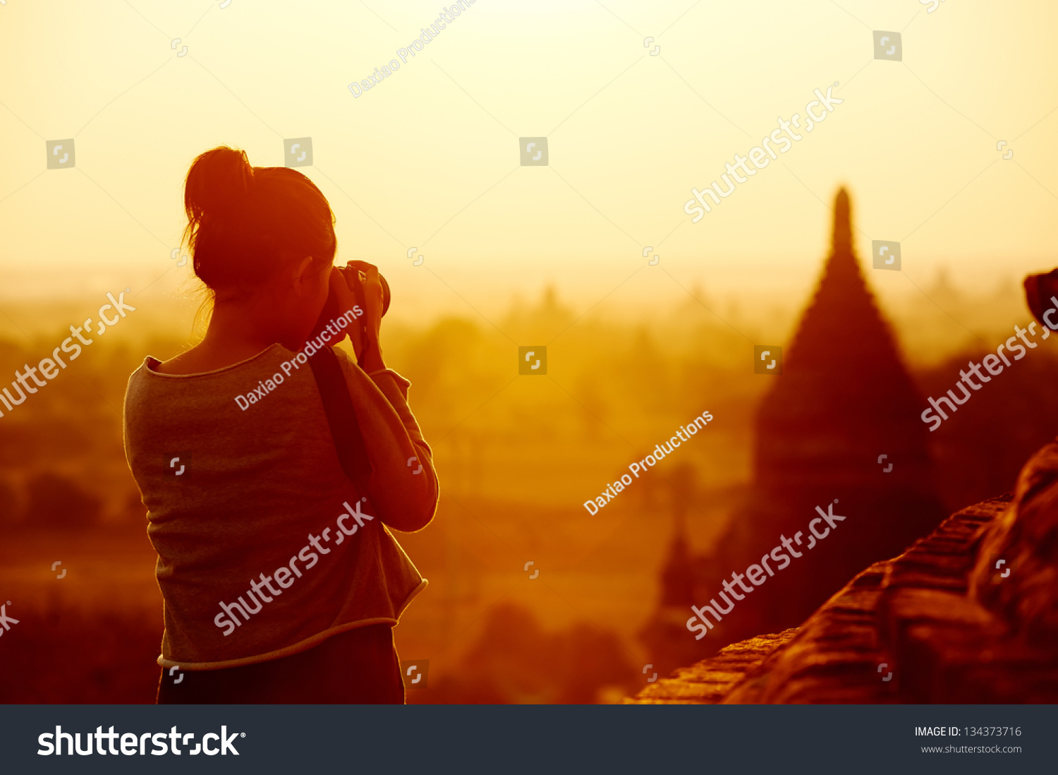 female traveler photographing temples at Bagan Myanmar Asia at sunrise