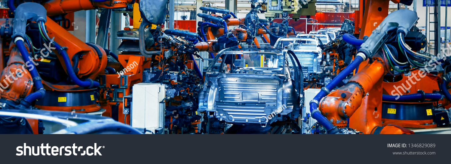 Automated robotic arm on the car production line is welding the car body