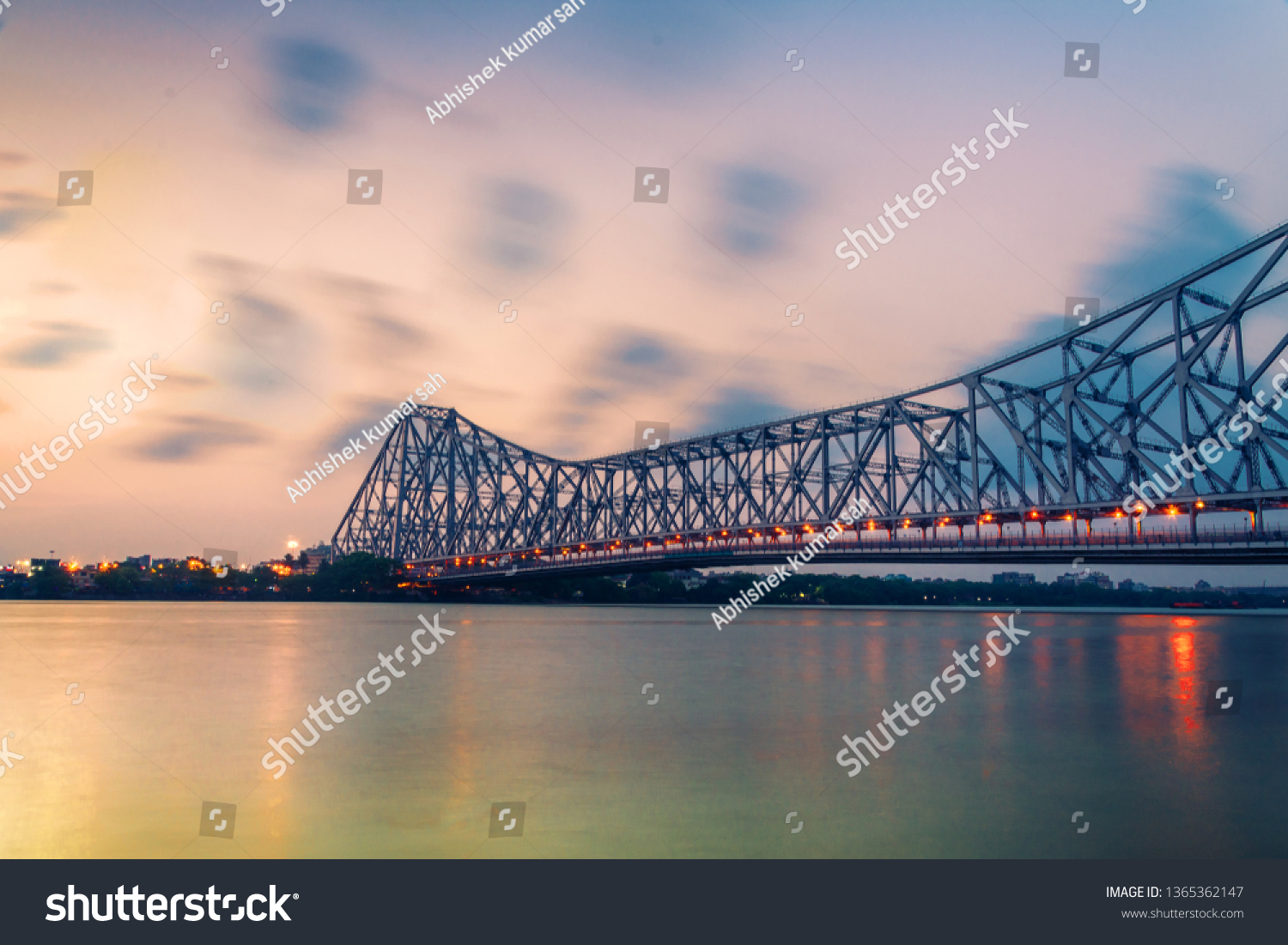 Howrah bridge - The historic cantilever bridge on the river Hooghly in West Bengal with twilight sky. Howrah bridge is considered as the busiest bridge in India. 