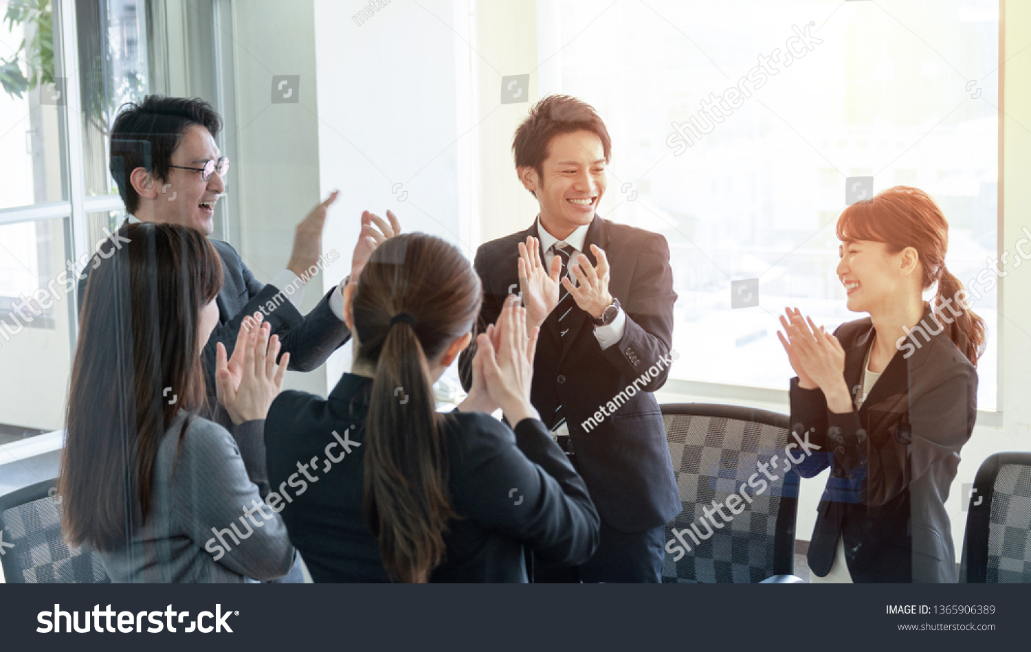 Group of people clapping their hands.