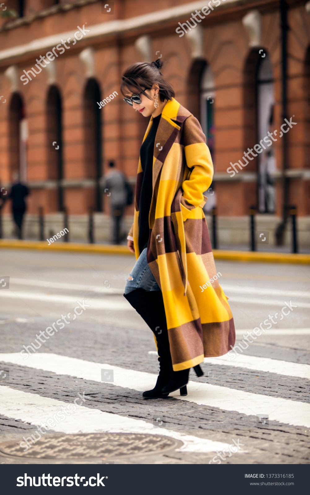 Asian fashion girl wearing yellow trench coat in the street