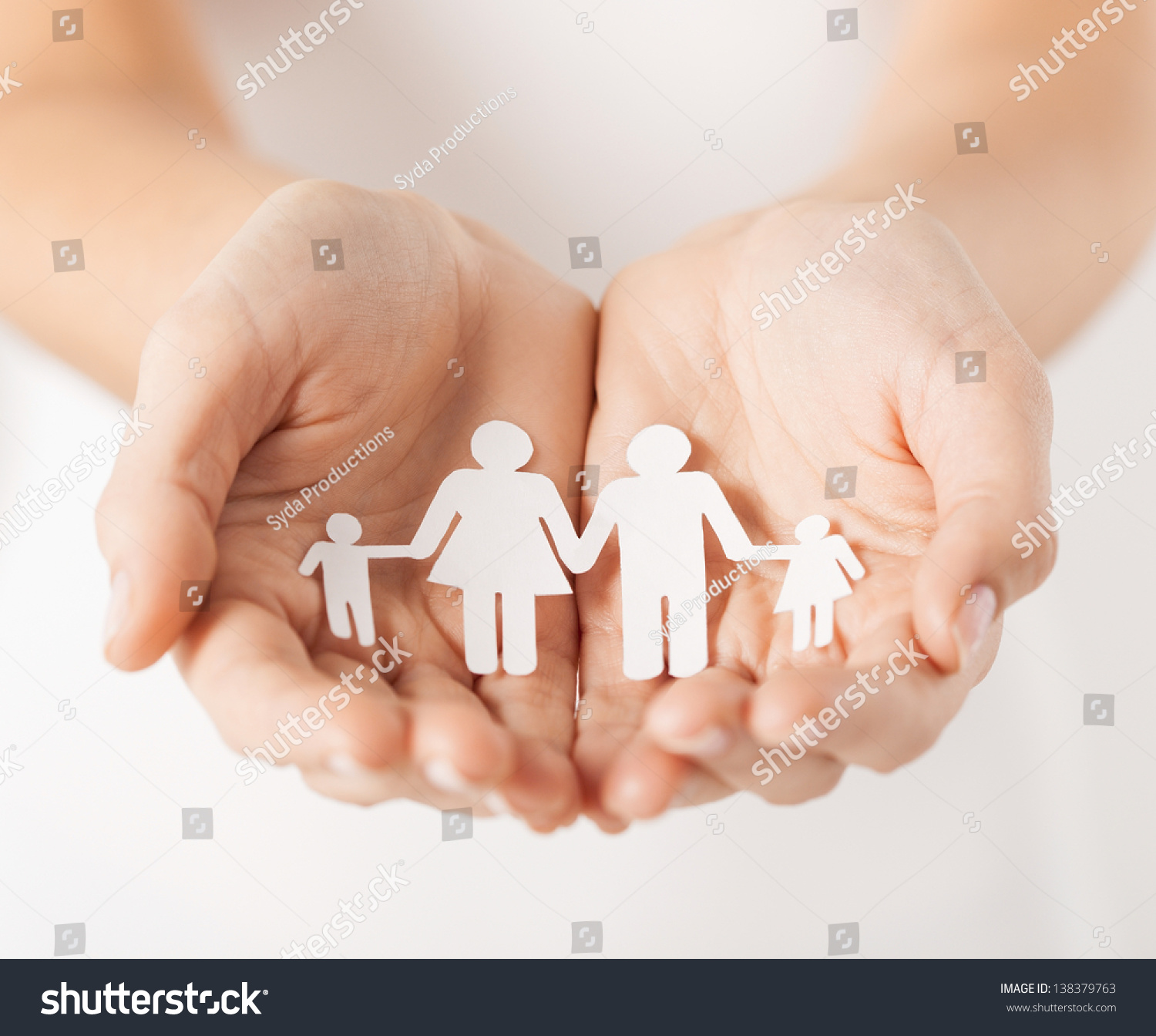 close up of womans cupped hands showing paper man family