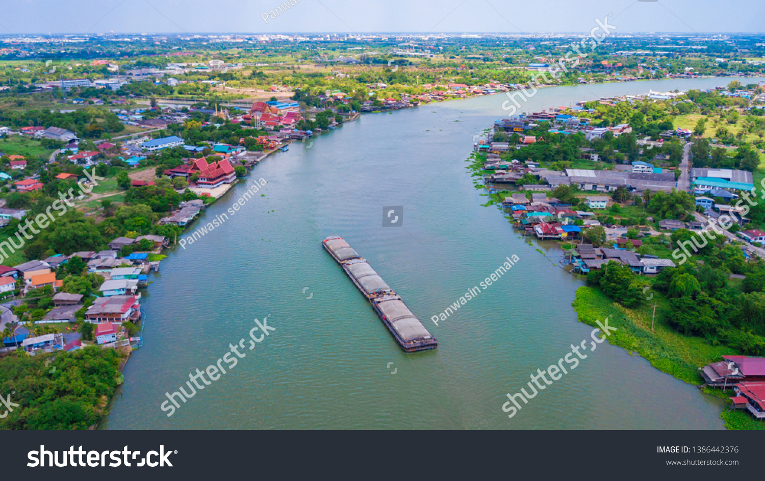 Aerial view of towing boat in Chao Phraya River Consisting of waterfront communities Temples including buildings in Thailand