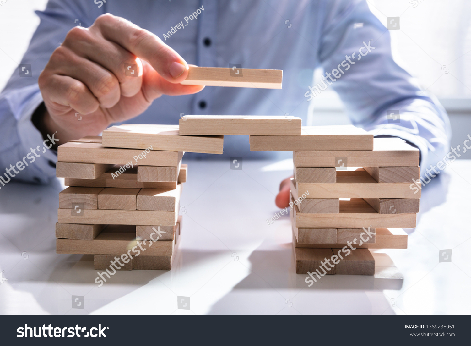 Conceptual Photo Of Businessman Building Bridge To Connect Two Towers