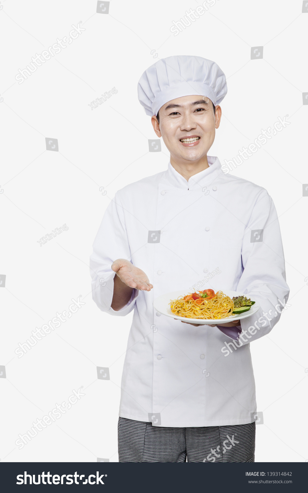 Chef showing prepared food  studio shot