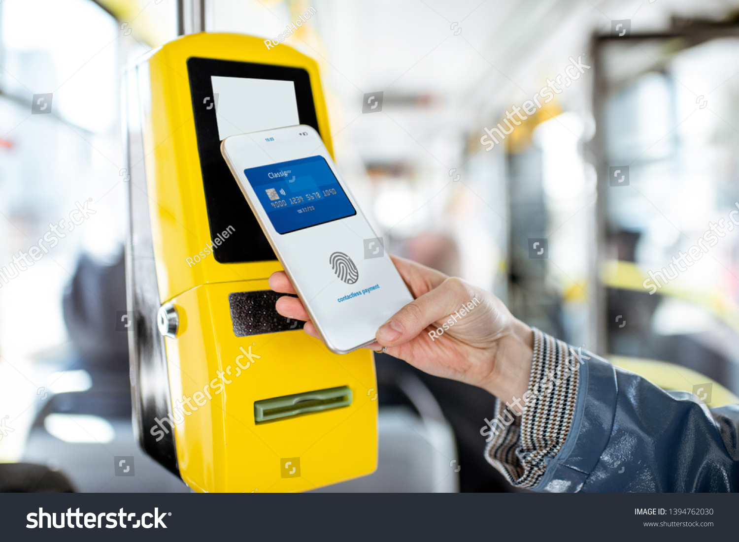 Paying conctactless with smartphone for the public transport in the tram  close-up view