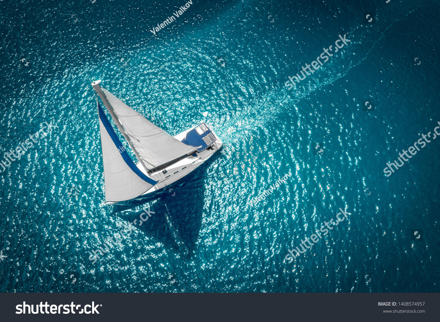 Regatta sailing ship yachts with white sails at opened sea. Aerial view of sailboat in windy condition.