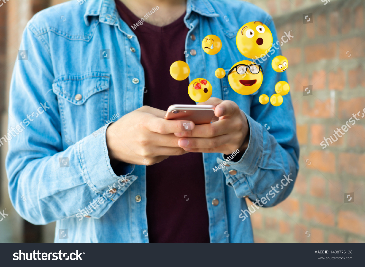 Close-up of man using smartphone sending emojis. Social concept.