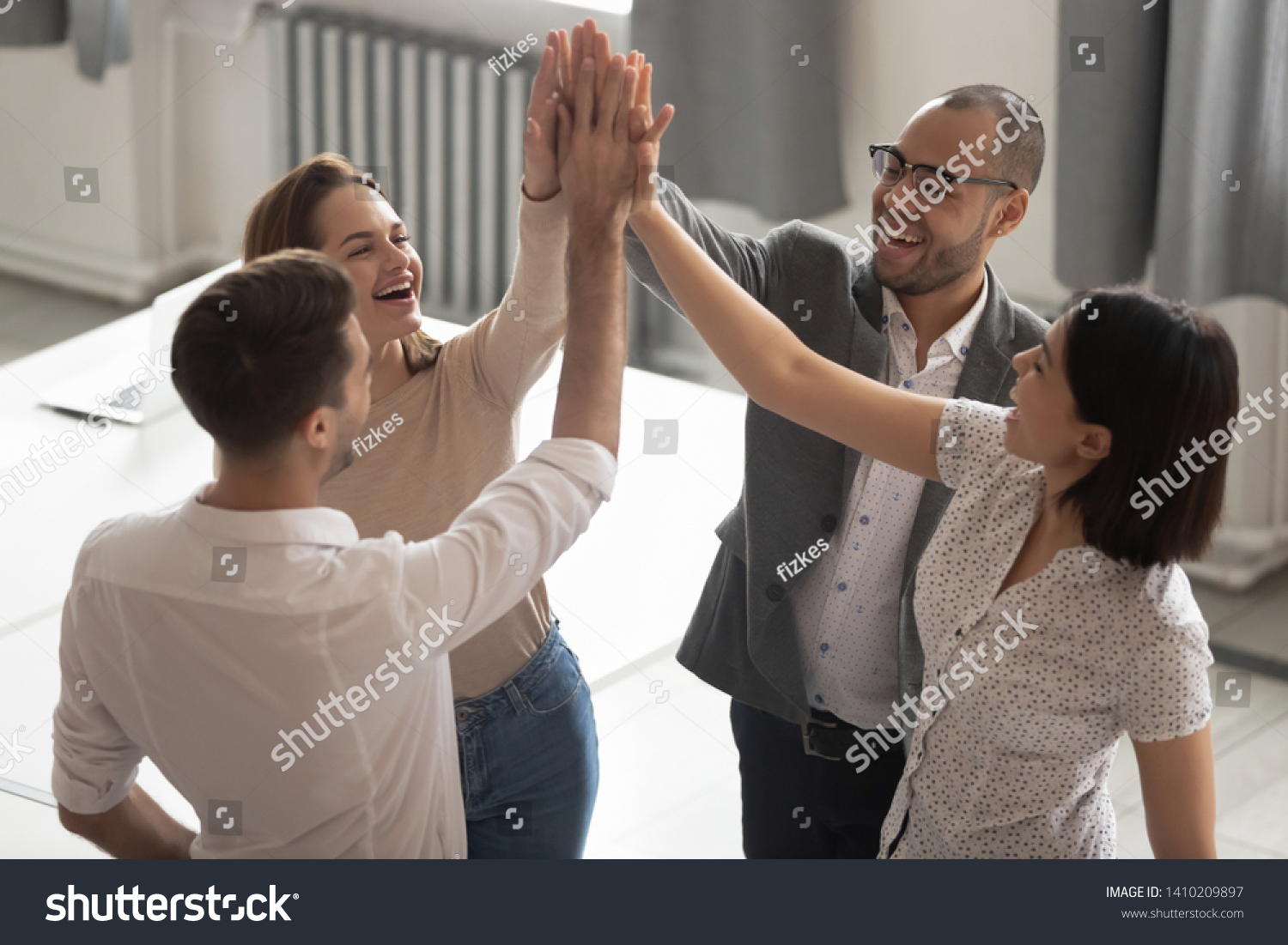 Happy motivated diverse business work team people employees group giving high five together engaged in teambuilding celebrate success good teamwork result shared win promise trust integrity concept
