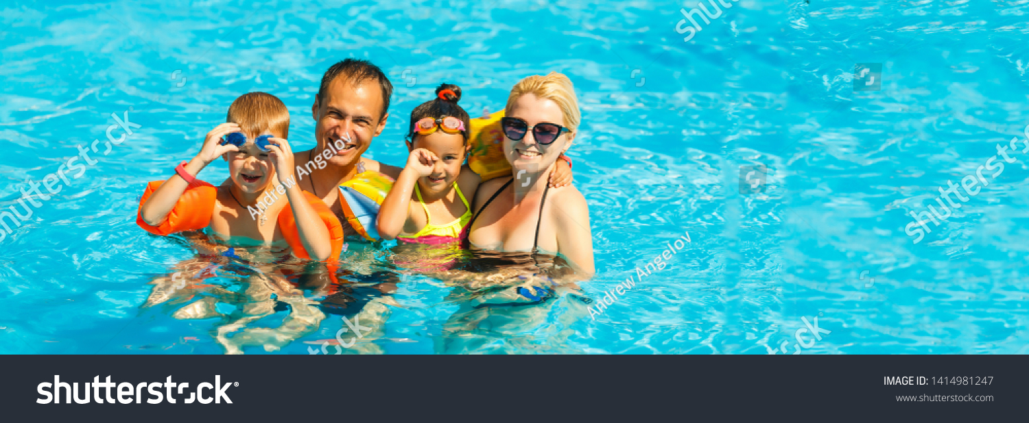 Happy family with two kids having fun in the swimming pool. Summer ...