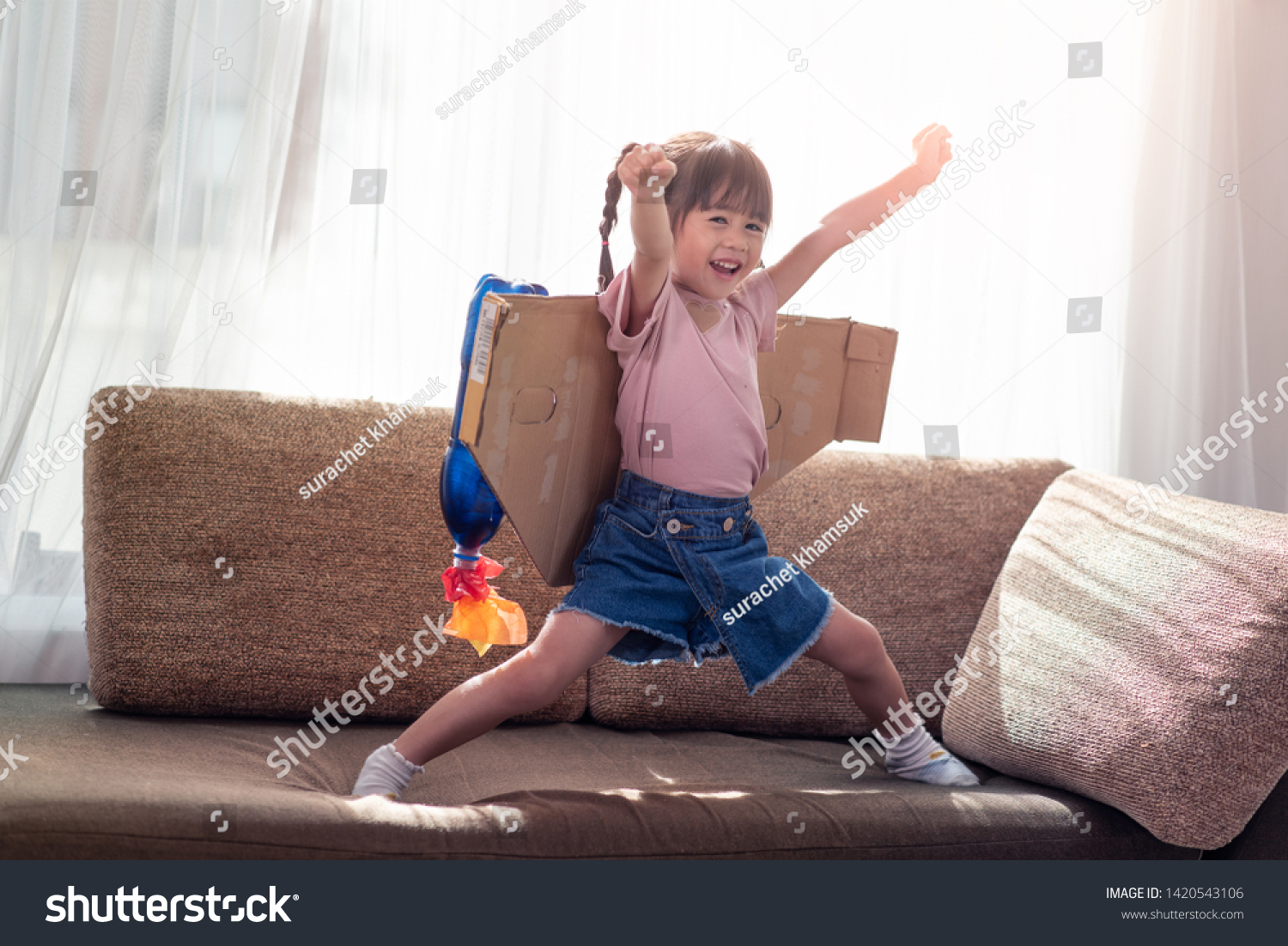 Portrait of happy Asian little child girl playing in an astronaut costume