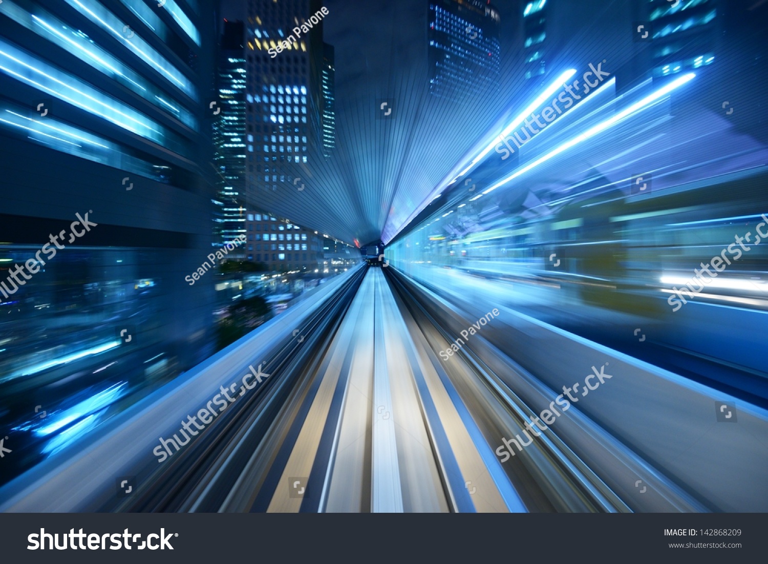 Motion blur of a city and tunnel from inside a moving monorail in Tokyo.