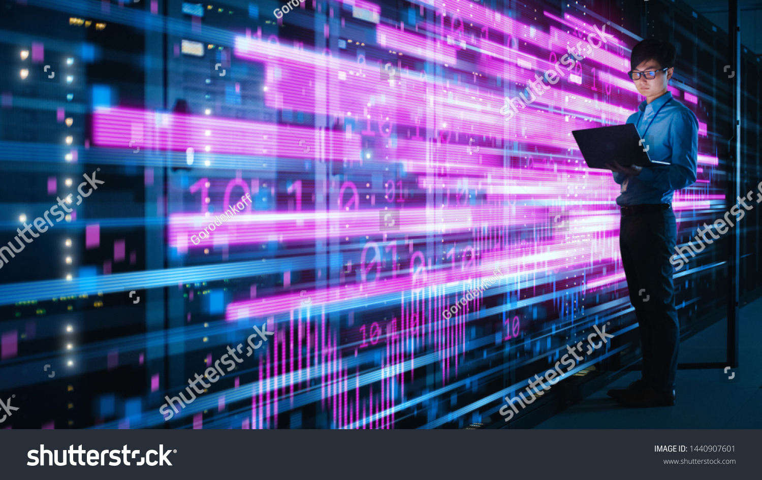Shot of Asian IT Specialist Using Laptop in Data Center Full of Rack Servers. Concept of High Speed Internet with Pink Neon Visualization Projection of Binary Data Transfer