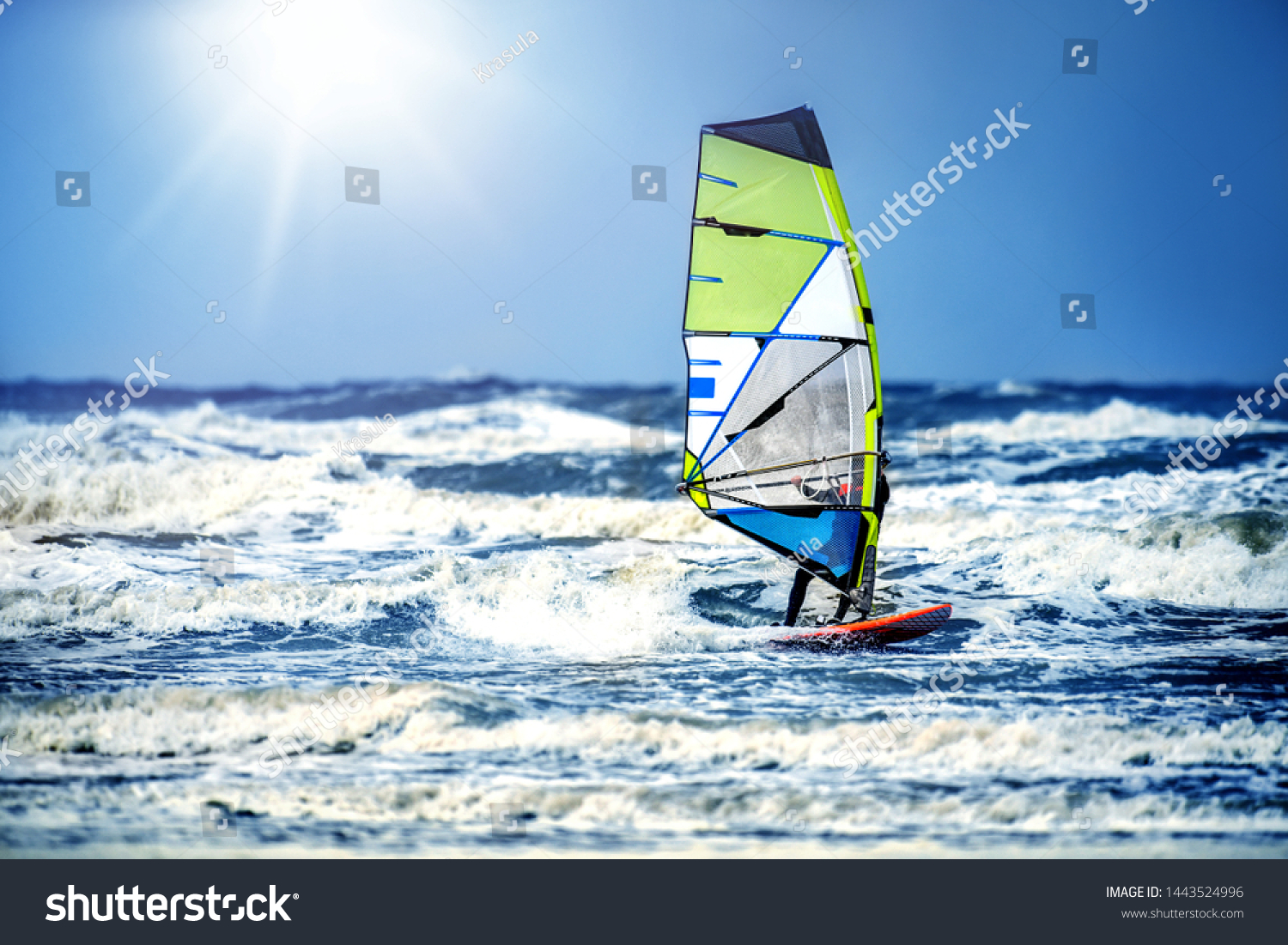 Windsurfing  Fun and action in the ocean water. Extreme sunny sport .