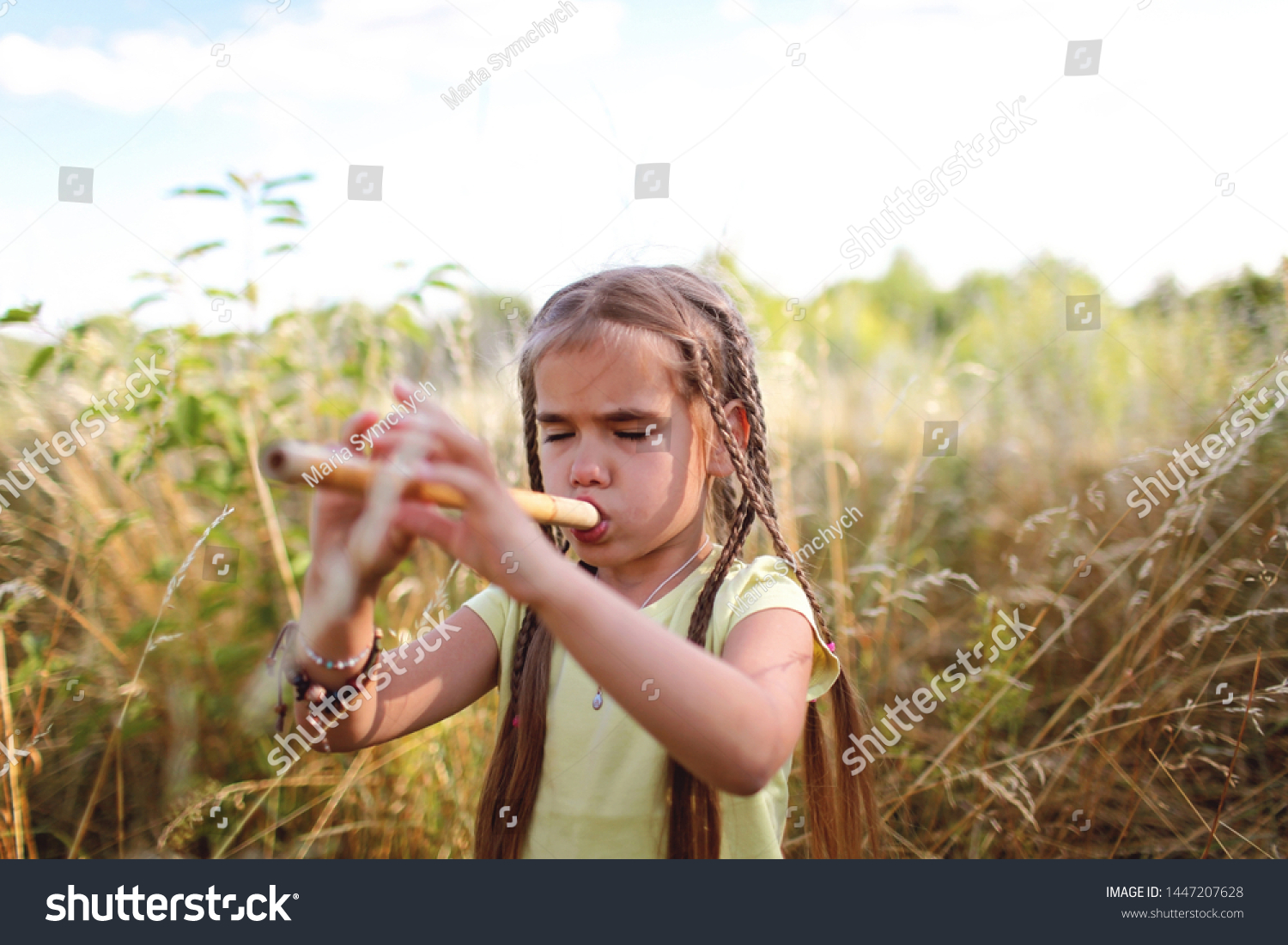 Cool 78 years old school girl with many braids playing a pipe at