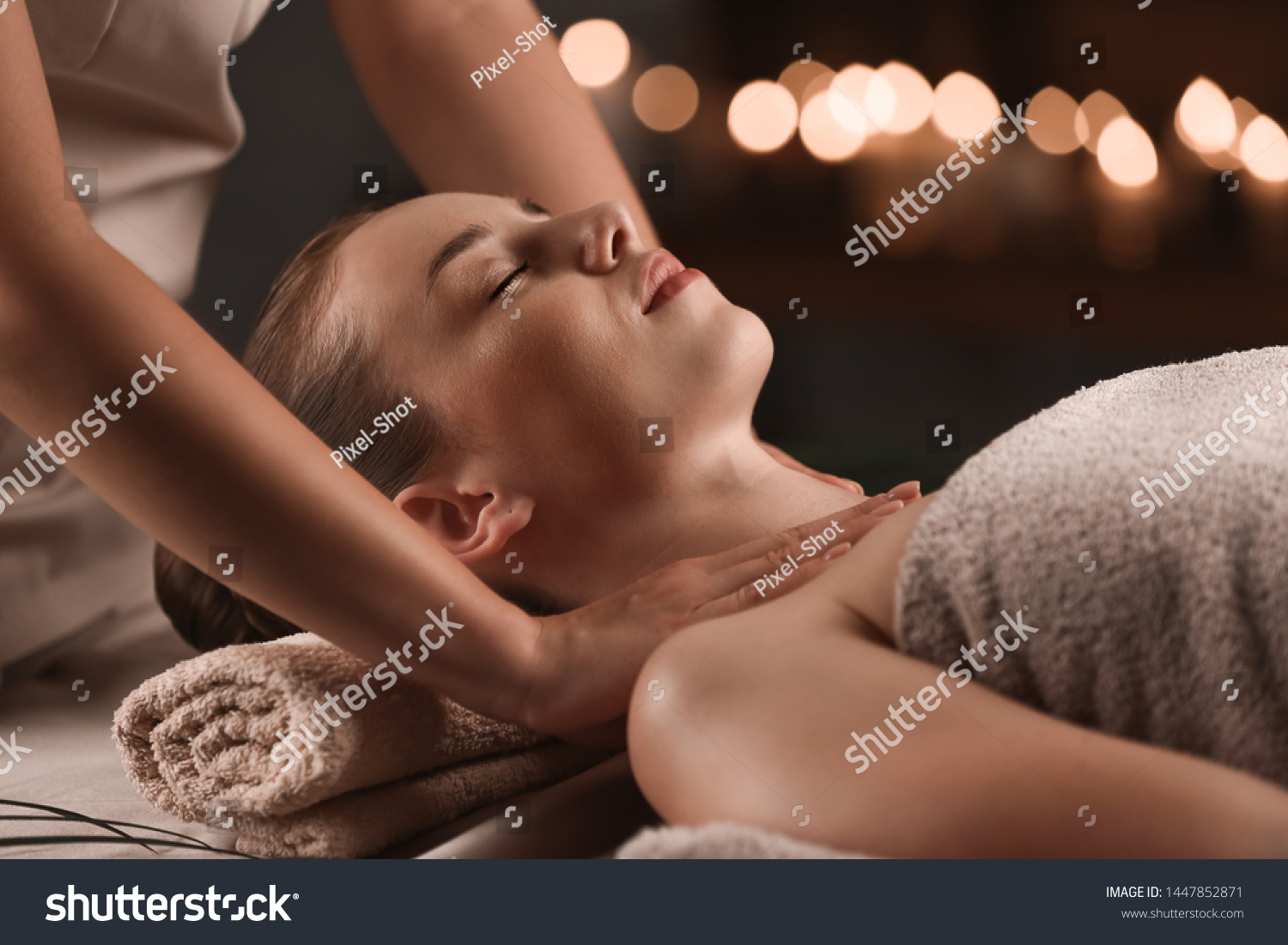 Young woman having massage in spa salon