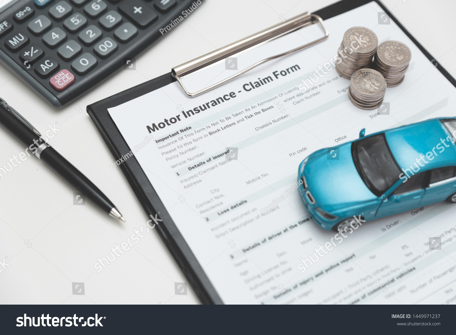 Motor or car insurance claim form with coin stack  calculator and car model.