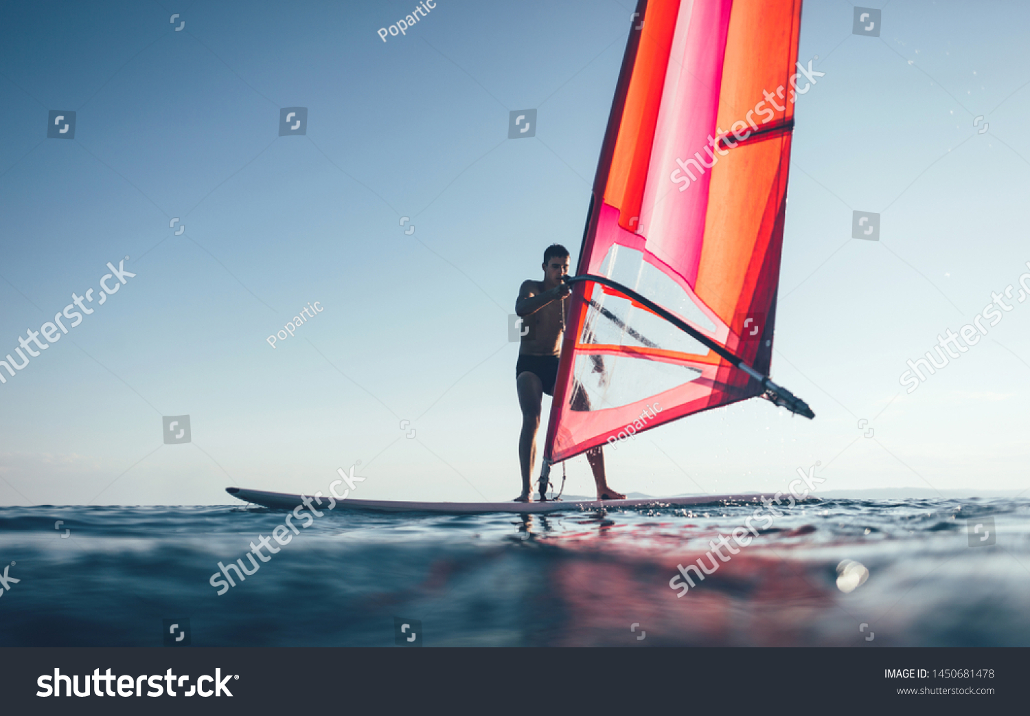 Windsurfer catch the wind on windsurf board