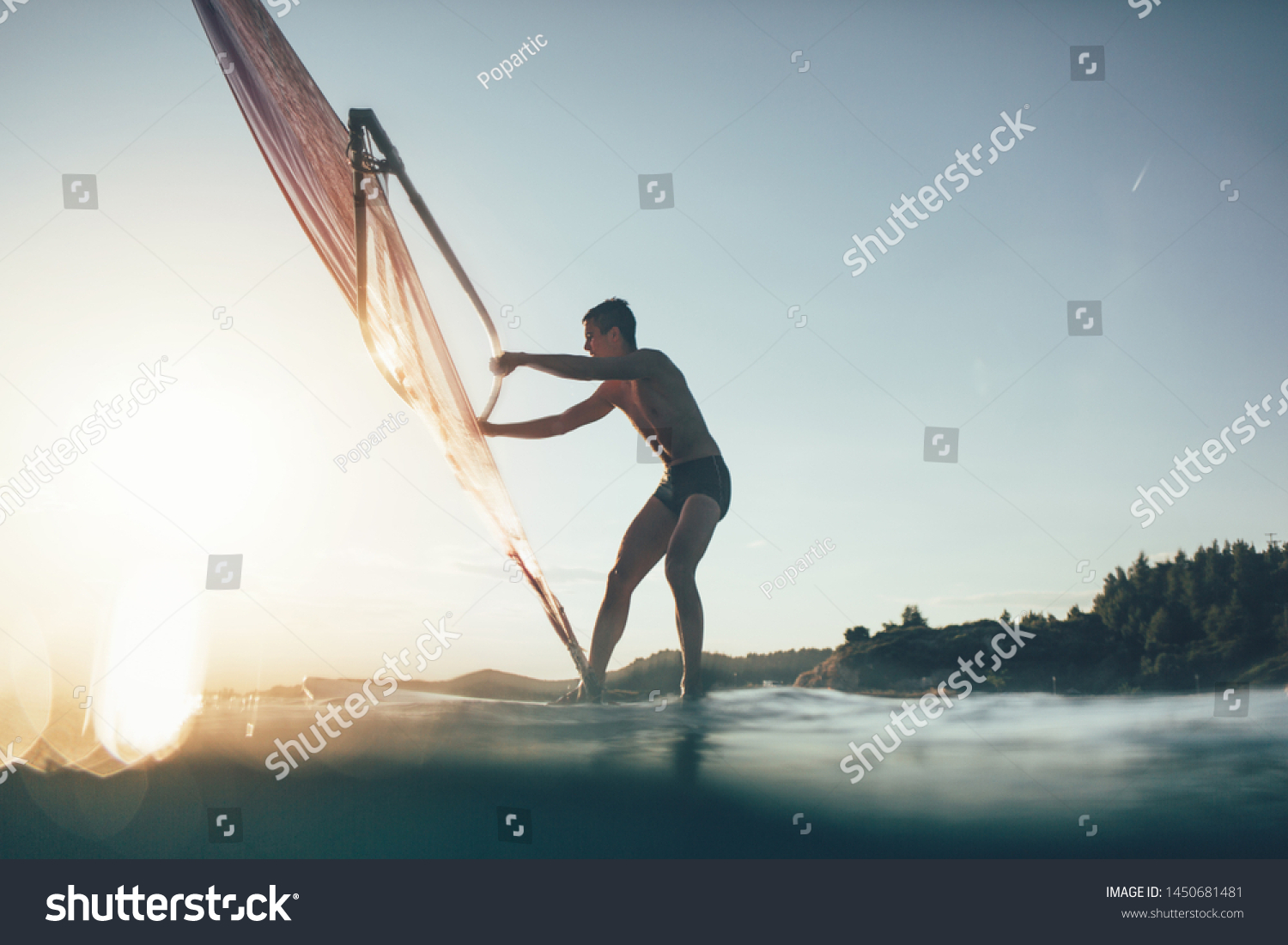 Low angle view of windsurfer sailing on the windsurf board