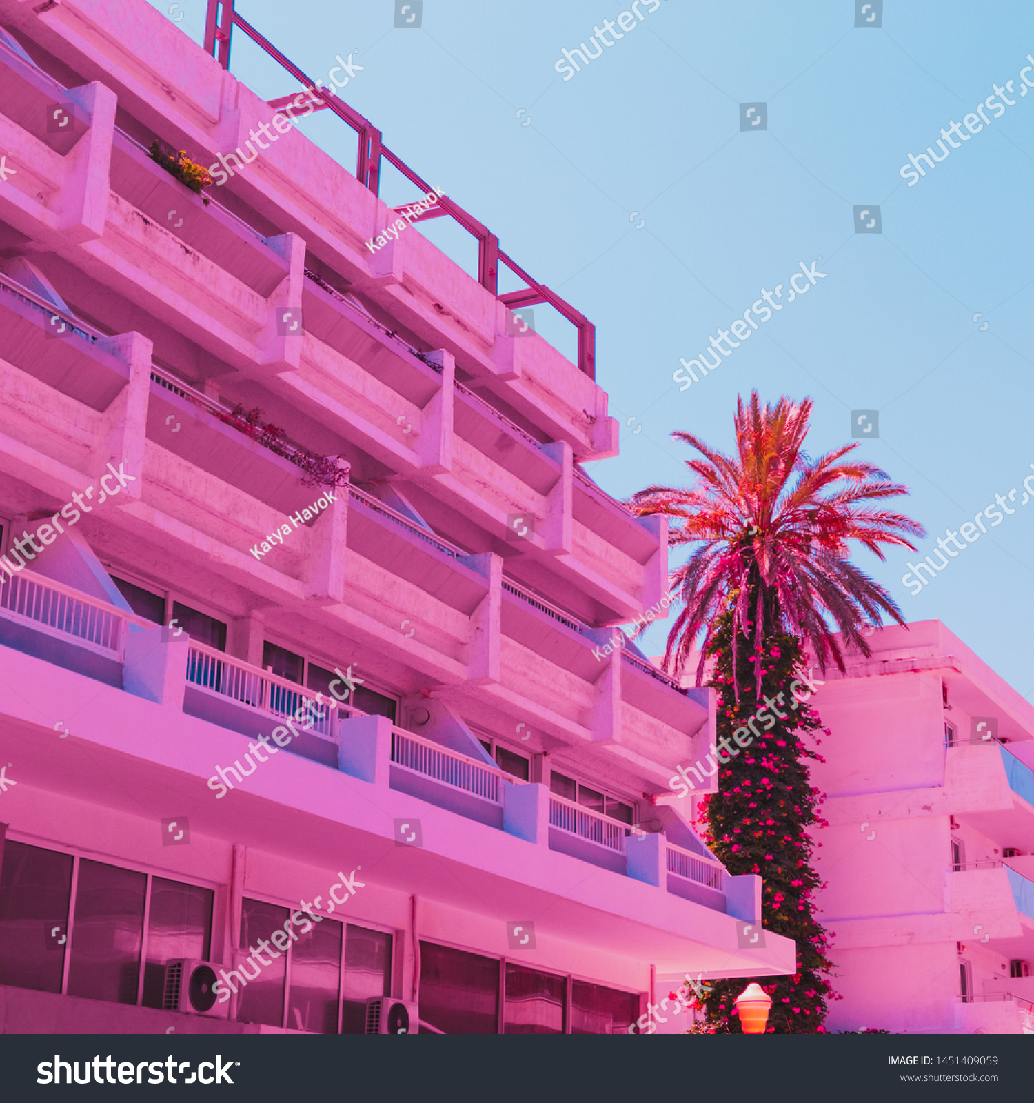 Wall of the hotel in infrared style and palm tree. Minimal