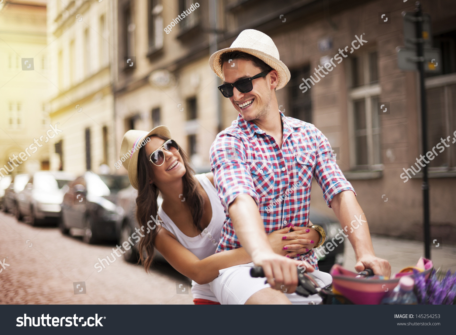 Handsome man taking his girlfriend on bicycle rack