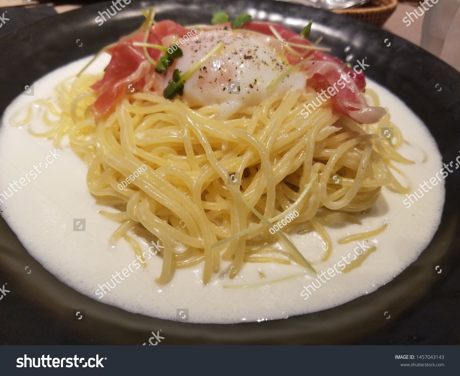 Uncured ham cream pasta topped with  hot spring egg.