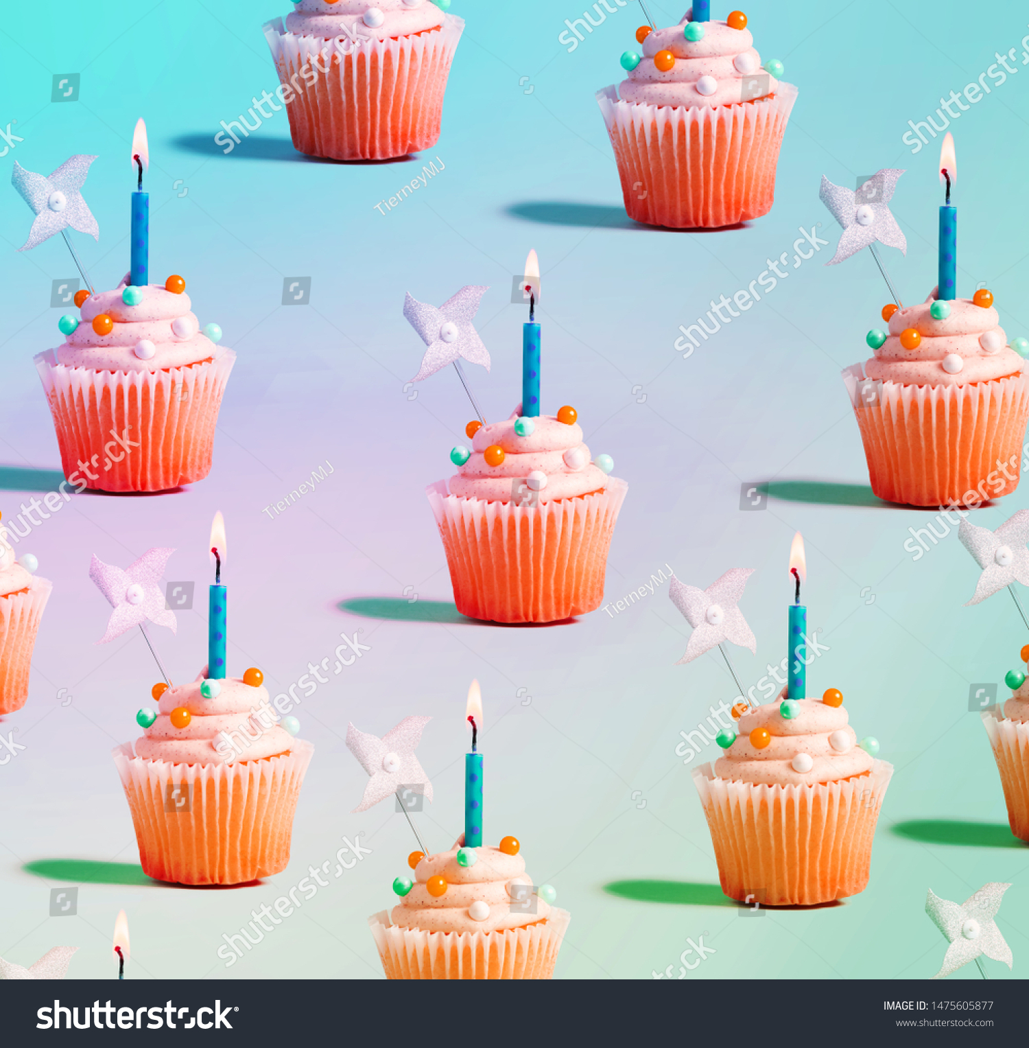Tasty celebratory cupcakes with decorative lit candles