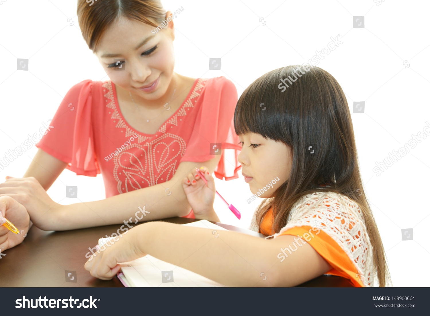 Mother with little girl studying.