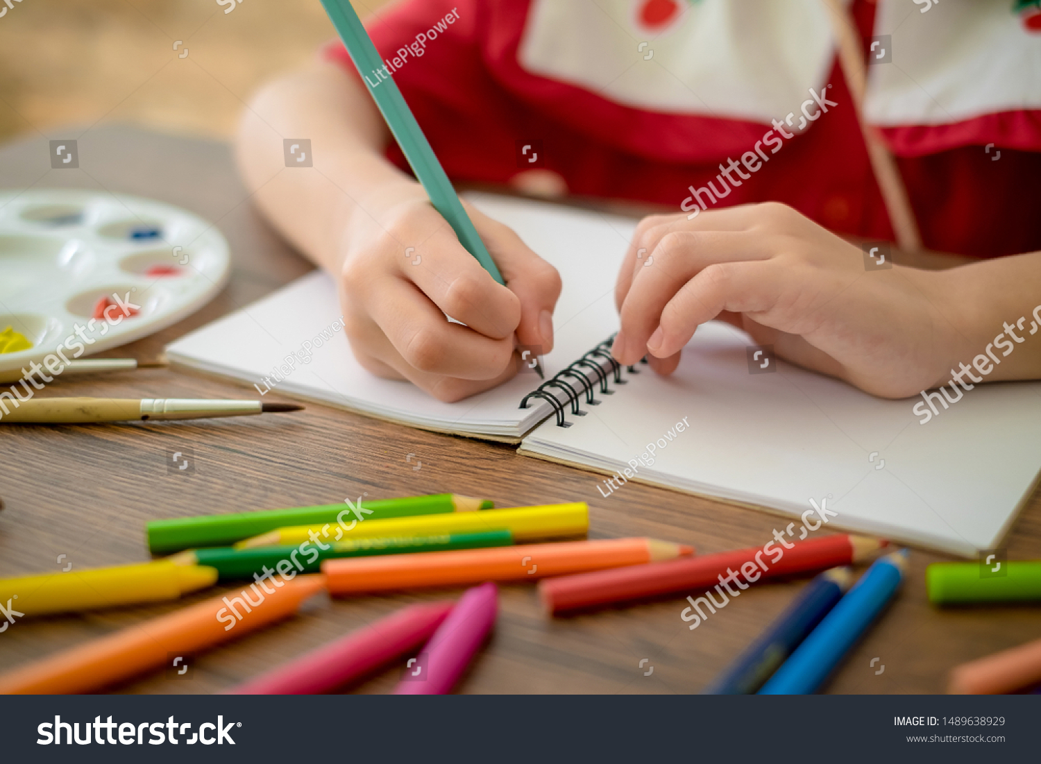 the childs hands are painted with colored penci