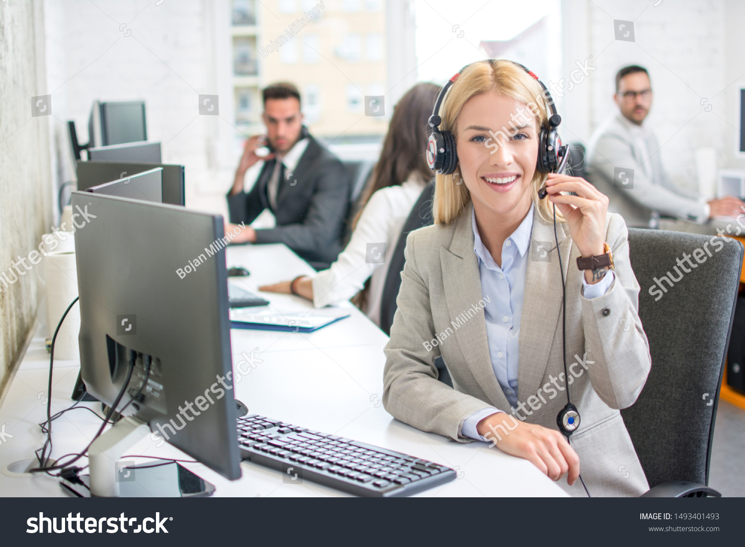 Portrait of smiling female customer service representative with ...